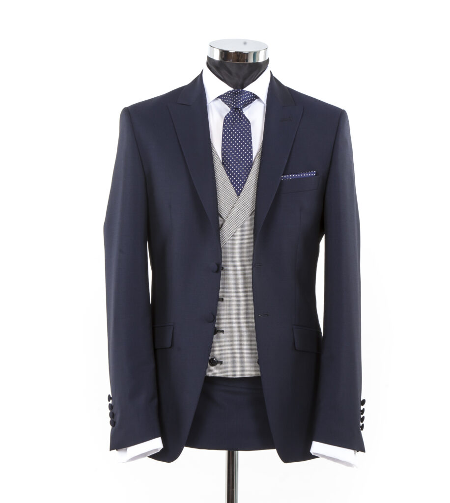 Slim Fitting Wedding Suit for Hire in 2025.  Navy blue wedding suit with great waistcoat and navy silk polka dot tie. 